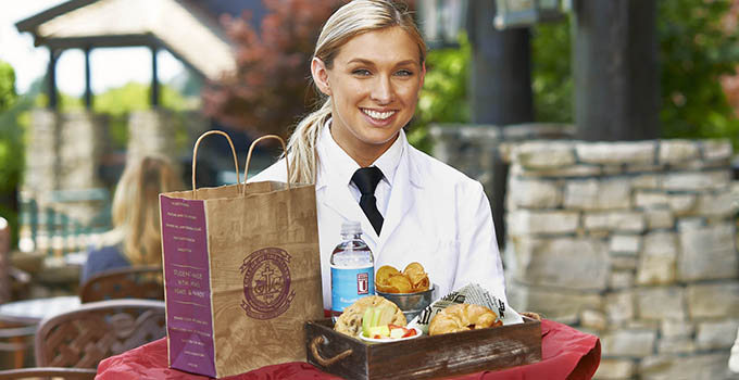 Student server carrying a to-go order.