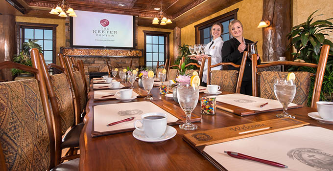 Conference table set with coffee and two student servers